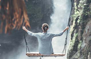 Image of a woman on an outdoor swing