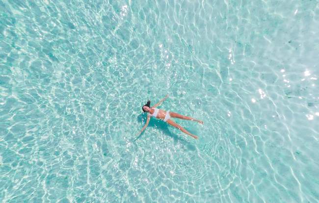 Image of woman getting a poolside back massage